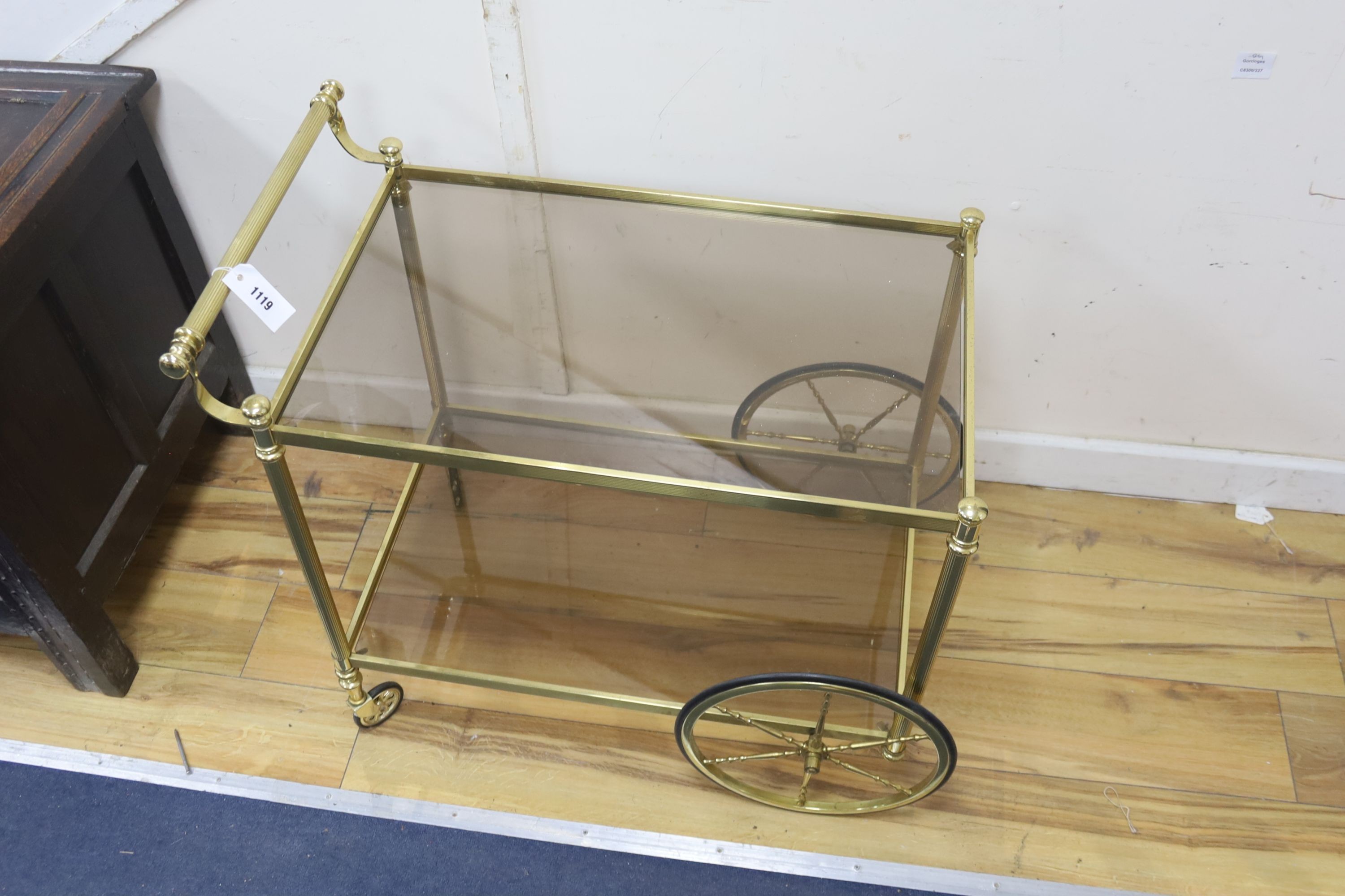 A Hollywood Regency brass and glass two tier drinks trolley, width 74cm, depth 44cm, height 70cm